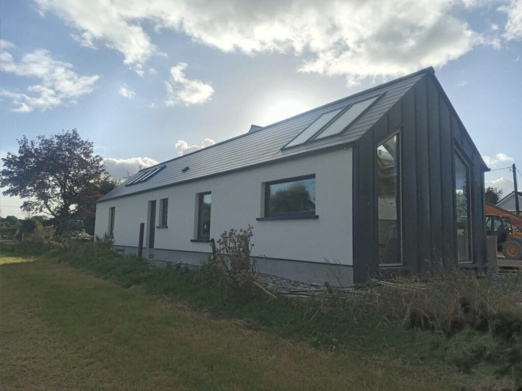 Shanette Steel Frame house extension with Standing Seam Gable end.